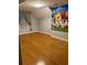 Spacious bedroom with wood floors and whimsical wall art; naturally well lit at 234 Sugar Mill Loop, Myrtle Beach, SC 29588