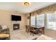 Inviting dining area with fireplace, table set for four, and large window with soft light at 234 Sugar Mill Loop, Myrtle Beach, SC 29588