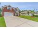 Spacious brick home boasting a wide driveway, three-car garage, and lush landscaping at 234 Sugar Mill Loop, Myrtle Beach, SC 29588