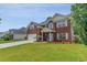 Beautiful two-story brick home featuring a manicured lawn and an attached two-car garage at 234 Sugar Mill Loop, Myrtle Beach, SC 29588
