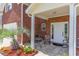 Inviting front porch with tiled flooring, seating, and lush landscaping at 234 Sugar Mill Loop, Myrtle Beach, SC 29588