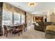 Open-concept living and dining area featuring large windows, hardwood floors, and updated kitchen at 234 Sugar Mill Loop, Myrtle Beach, SC 29588
