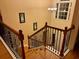 An elegant staircase with dark iron railing, light wood steps, and a bright window at 234 Sugar Mill Loop, Myrtle Beach, SC 29588