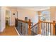 Elegant staircase with dark iron railing and light wood steps, leading to the upper level at 234 Sugar Mill Loop, Myrtle Beach, SC 29588