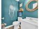 Charming powder room with teal walls and white vanity at 281 Sugar Mill Loop, Myrtle Beach, SC 29588