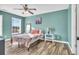 Bedroom with floral bedding, wood floors, and a window at 281 Sugar Mill Loop, Myrtle Beach, SC 29579