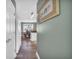Hallway with light grey walls, wood-look flooring, and view into dining area at 281 Sugar Mill Loop, Myrtle Beach, SC 29588