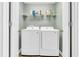 Bright laundry room with washer, dryer, and shelving at 281 Sugar Mill Loop, Myrtle Beach, SC 29588