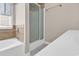 Bathroom featuring a tub with glass doors and tiled walls at 290 Georgia Mae Loop, Conway, SC 29527
