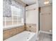 A cozy bathroom features a combination shower and tub, a tile surround, and a window at 290 Georgia Mae Loop, Conway, SC 29527