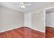 A bright bedroom with a ceiling fan, closet, shelf, and wood-look floors at 290 Georgia Mae Loop, Conway, SC 29527
