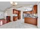 Well-lit kitchen with white tile, stainless steel appliances, and dark brown cabinets and island at 290 Georgia Mae Loop, Conway, SC 29527