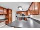 Functional kitchen featuring stainless steel appliances, dark counters, and wooden cabinets at 290 Georgia Mae Loop, Conway, SC 29527