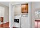 A convenient laundry room with a modern washer, dryer, storage, and wood-look floors at 290 Georgia Mae Loop, Conway, SC 29527