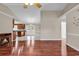 Open-concept living room and kitchen with a cozy fireplace and hardwood floors at 290 Georgia Mae Loop, Conway, SC 29527