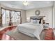 The primary bedroom features ample natural light, a ceiling fan, and wood-look floors at 290 Georgia Mae Loop, Conway, SC 29527