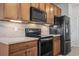 Well-equipped kitchen featuring black appliances and wood cabinets at 3210 Volterra Way, Myrtle Beach, SC 29579