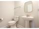 Small bathroom with pedestal sink, toilet, and gold mirror at 3339 Moss Bridge Ln., Myrtle Beach, SC 29579