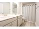 Bathroom with double vanity, shower, and light gray cabinets at 3339 Moss Bridge Ln., Myrtle Beach, SC 29579