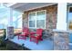 Front porch with stonework and two red adirondack chairs at 3339 Moss Bridge Ln., Myrtle Beach, SC 29579