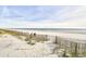Sandy beach with wooden fence at 3601 S Ocean Blvd. # 7-E, North Myrtle Beach, SC 29582