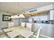 Dining area with glass table and kitchen view at 3601 S Ocean Blvd. # 7-E, North Myrtle Beach, SC 29582