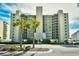 Oceanfront building with palm trees and ample parking at 3601 S Ocean Blvd. # 7-E, North Myrtle Beach, SC 29582