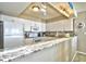 Modern kitchen featuring granite countertops and white cabinetry at 3601 S Ocean Blvd. # 7-E, North Myrtle Beach, SC 29582