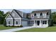 Two-story farmhouse style home with gray siding, white trim, and a large front yard at 364 Ridge Dr., Galivants Ferry, SC 29544