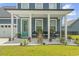 Quaint front porch with teal door and landscaping at 375 Bumble Circle, Murrells Inlet, SC 29576