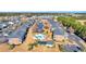 Wide aerial shot of an apartment complex showcasing landscaping, a pool, and a serene pond at 3923 Gladiola Ct. # 301, Myrtle Beach, SC 29588
