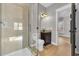 Bathroom featuring a glass shower, granite vanity, and a glimpse into an adjacent room at 3923 Gladiola Ct. # 301, Myrtle Beach, SC 29588