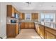 Kitchen featuring stainless steel appliances, granite counters, light oak cabinetry, and hardwood floors at 3923 Gladiola Ct. # 301, Myrtle Beach, SC 29588