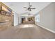 Open-concept room with wood-accent wall, hardwood floors, and a kitchen in the background at 3923 Gladiola Ct. # 301, Myrtle Beach, SC 29588