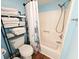 This updated bathroom offers a tub/shower combo with a curtain and a shelf for storage at 410 Melrose Pl. # 219, Myrtle Beach, SC 29572