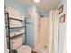 Bathroom features a large stack of white towels, a shower, and blue painted walls at 410 Melrose Pl. # 219, Myrtle Beach, SC 29572