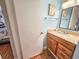 This bathroom features blue walls and a vanity with drawers and storage space at 410 Melrose Pl. # 219, Myrtle Beach, SC 29572