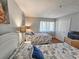 Cozy bedroom features two beds with nautical themed linens, hardwood floors, and ample closet space at 410 Melrose Pl. # 219, Myrtle Beach, SC 29572