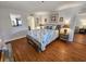 A beautifully furnished bedroom with stylish decor and wood-look flooring throughout at 410 Melrose Pl. # 219, Myrtle Beach, SC 29572