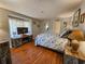 Comfortable bedroom boasts wood-look flooring, a cozy bed, TV, and beach-themed decor at 410 Melrose Pl. # 219, Myrtle Beach, SC 29572