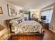 This airy bedroom offers beautiful furnishings, a cozy bed, and lovely lighting fixtures at 410 Melrose Pl. # 219, Myrtle Beach, SC 29572