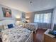 This inviting bedroom features two twin beds and bright, neutral colors at 410 Melrose Pl. # 219, Myrtle Beach, SC 29572