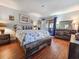 This spacious bedroom offers wood-look floors, a comfortable bed, and sliding door access at 410 Melrose Pl. # 219, Myrtle Beach, SC 29572