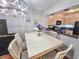 Bright dining area adjacent to kitchen with modern light fixture and view to the kitchen at 410 Melrose Pl. # 219, Myrtle Beach, SC 29572