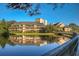 Beautiful view of an exterior building with waterfront access and a wooden bridge over the lake at 410 Melrose Pl. # 219, Myrtle Beach, SC 29572