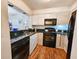 Charming kitchen with stainless steel sink and wood-look flooring at 410 Melrose Pl. # 219, Myrtle Beach, SC 29572