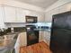 Efficient kitchen layout with black appliances, granite countertops, and wood-look flooring at 410 Melrose Pl. # 219, Myrtle Beach, SC 29572
