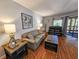 Cozy living room with comfortable seating, stylish decor, and wood-look flooring throughout at 410 Melrose Pl. # 219, Myrtle Beach, SC 29572
