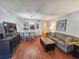 Open-concept living space with hardwood floors, comfortable seating, and dining area at 410 Melrose Pl. # 219, Myrtle Beach, SC 29572