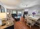 Open living space with couches, TV, chandelier, dining table, and a view of the balcony at 410 Melrose Pl. # 219, Myrtle Beach, SC 29572